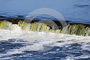 Fish jumps on waterfall Ventas rumba at Kuldiga city, Latvia