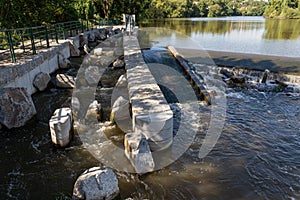 Fish ladder, fishway, fish pass or fish steps passage though weir crossing on  river photo