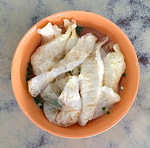Fish maw in clear broth soup photo