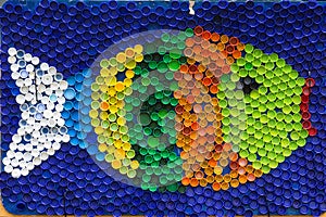 Fish mosaic deocoration made of cororful plastic bottle caps . S