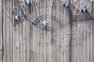 Fish Net with Floats on Wooden Fence