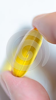 Fish oil capsule held by finger