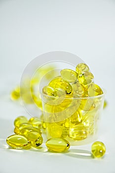 Fish oil capsule in the medicine cup.