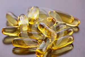 Fish oil capsules with omega 3 and vitamin D in a glass bottle