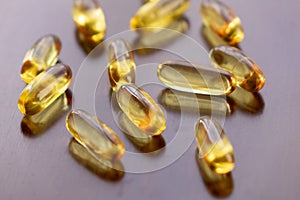 Fish oil capsules with omega 3 and vitamin D in a glass bottle