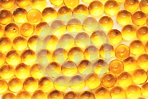 Fish oil capsules with omega 3 and vitamin D blue texture, healthy diet concept, selective focus