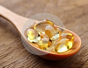 Fish oil capsules in a spoon