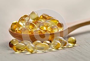 Fish oil capsules in a spoon