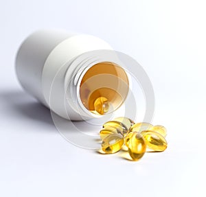 Fish oil capsules with a white pill bottle