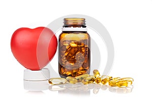 Fish oil gel capsule with bottle and heart shaped prop. It containing omega-3 polyunsaturated acid EPA and DHA enhances heart and