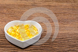 fish oil in heart shape bowl