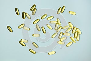 Fish oil omega 3 gel capsules isolated on blue background