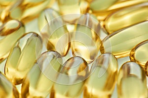 Fish oil, omega 3 gel capsules scattered, lying randomly. Health care, vitamins and treatment concept