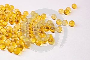 Fish oil pills arranged on white background