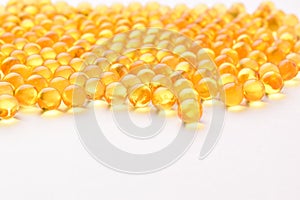 Fish oil pills arranged on white background
