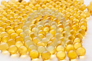 Fish oil pills arranged on white background