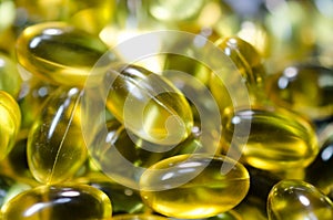 Fish oil pills closeup on black plate macro