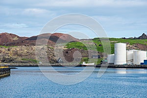 Fish oil tanks and historic buildings in Vestmannaeyjar Iceland