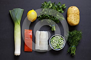 Fish pie ingredients on black background