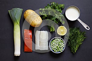 Fish pie ingredients on black background