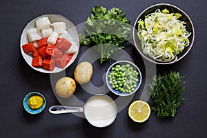 Fish pie ingredients on black background