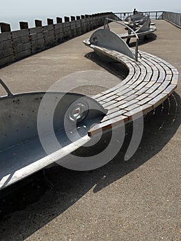 Fush plaques placed on iconic benches made of curved timber with metal fish as their backrests Seaford East Sussex photo