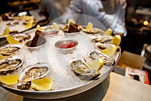 Fish restaurant. Raw oysters on tray with ice
