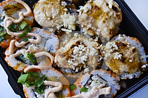Fish rolls with sauce. Japanese sushi rolls. Rice breakfast of rolls