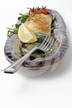 Fish and salad on earthenware platter