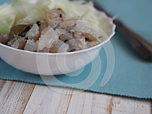 Fish salad Xe from freshly salted river fish pike on an ancient wooden table