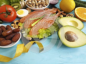 Fish salmon date salad health lemon nourishment centimeter omega 3 avocado on blue wooden background healthy food