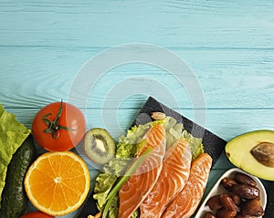 Fish salmon eating dinner health product on a blue wooden background different