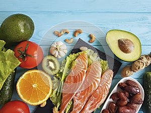 Fish salmon eating dinner health on a blue wooden background different