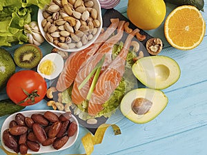 Fish salmon salad health lemon nourishment omega 3 avocado on blue wooden background healthy food