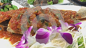Fish served with hot chili sauce or sambal in traditional grinder. thai food