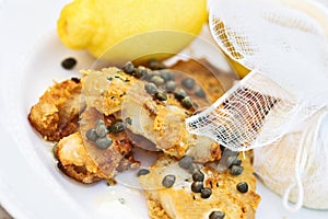 Fish Served With Lemons Tied in Cheesecloth photo