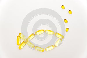 Fish shape Cod Liver Oil Capsules, Omega 3, Vitamin D on white background