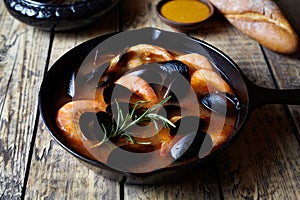 Fish soup bouillabaisse. Mussels and shrimp in tomato sauce. The traditional dish of Marseilles. Rustic style.