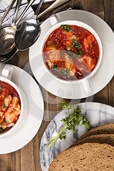 Fish soup in a bowl with home baked bread