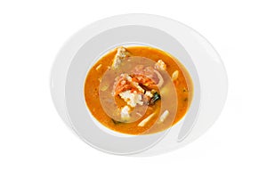 Fish soup in a bowl on white isolated background. Top view, close-up