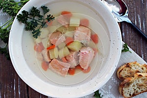 Fish soup with potatoes, carrot, and parsley