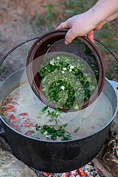 Fish soup prepared over an open fire.