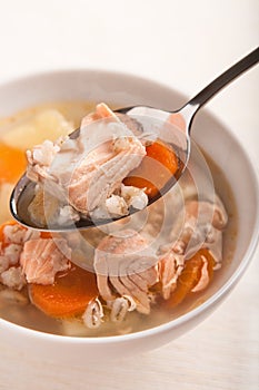 Fish soup with salmon and orge perlÃÂ© in spoon photo