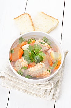 Fish soup on white wooden table