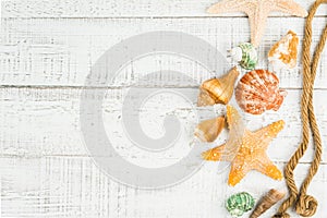 Fish star and sea shells on the wooden background