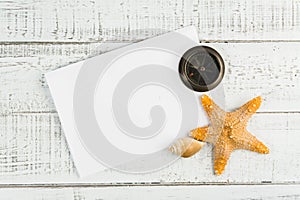 Fish star and sea shells on the wooden background