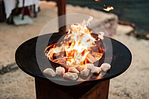 Fish steaks are grilled. Close-up of pieces of fish. Round grill bowl, round roaster with a fire in the center.
