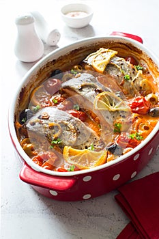 Fish steaks, olives and cherry tomatoes stewed  in tomato sauce