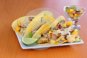 Fish tacos served with a mango salsa