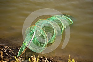 Fish tank on the river bank in the water